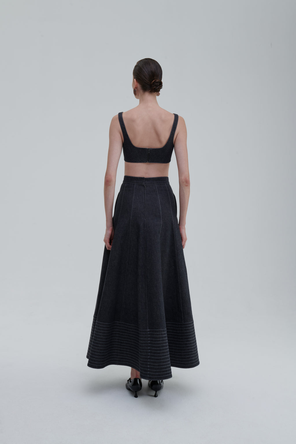 Back view of model wearing SAGIO Quilted Denim Top and matching skirt