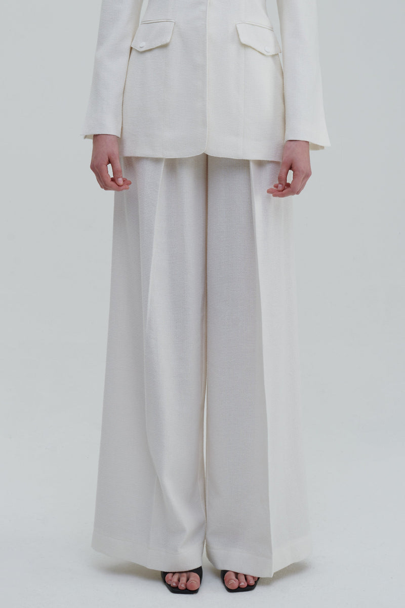White classic palazzo trousers detail, front lower view with wide-leg drape