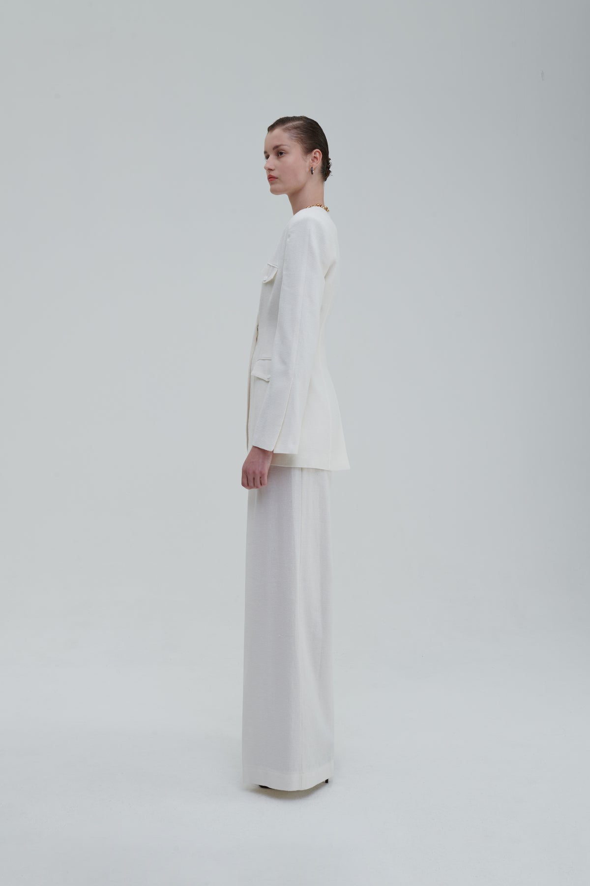 White palazzo trousers with matching blazer, side full-length view