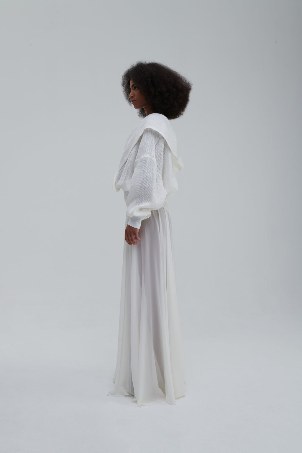Side profile, draped mesh sleeves and hood, long skirt styling