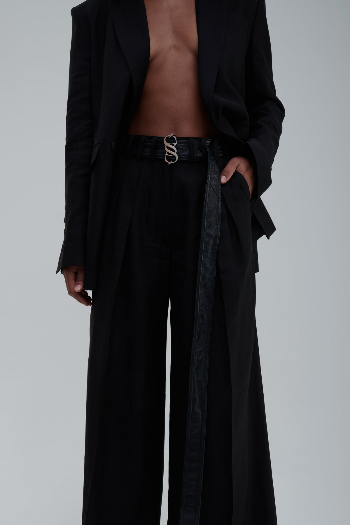 Black high-waist wide-leg trousers, front detail view