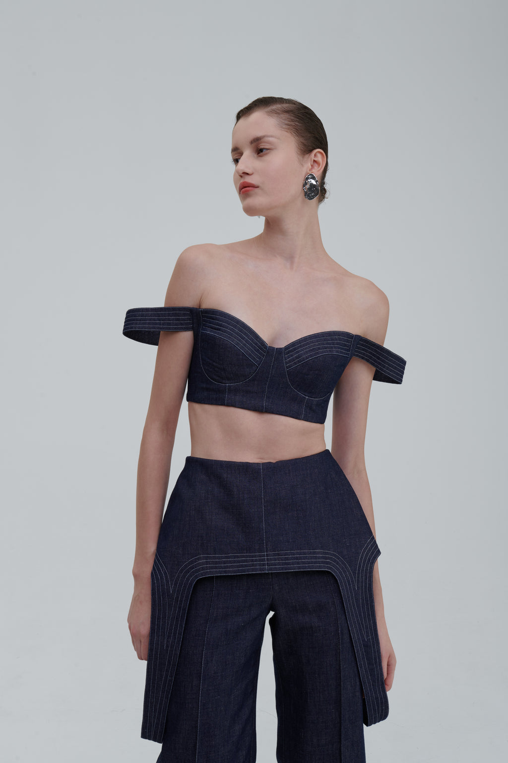 Dark indigo denim falling top with off-shoulder straps, three-quarter front view