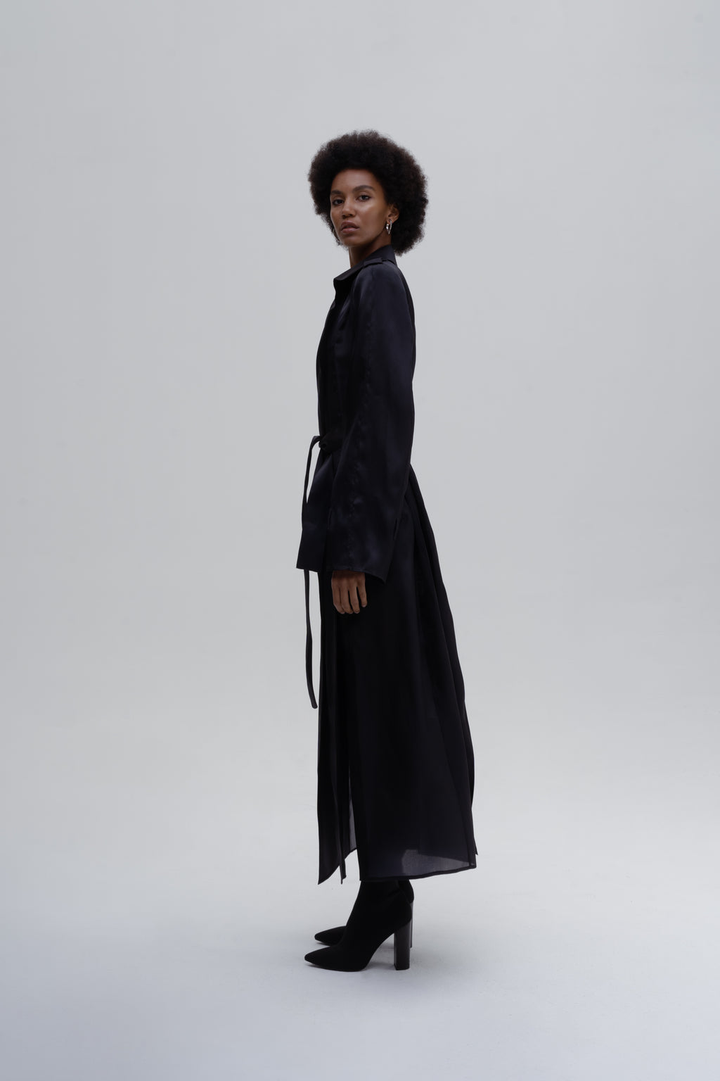 Women’s black silk trench coat with belt, side slits and wide lapels
