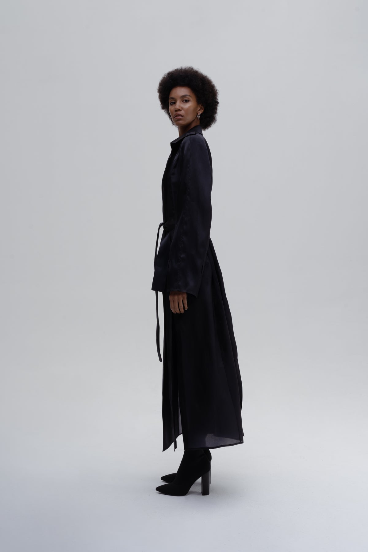Women’s black silk trench coat with belt, side slits and wide lapels
