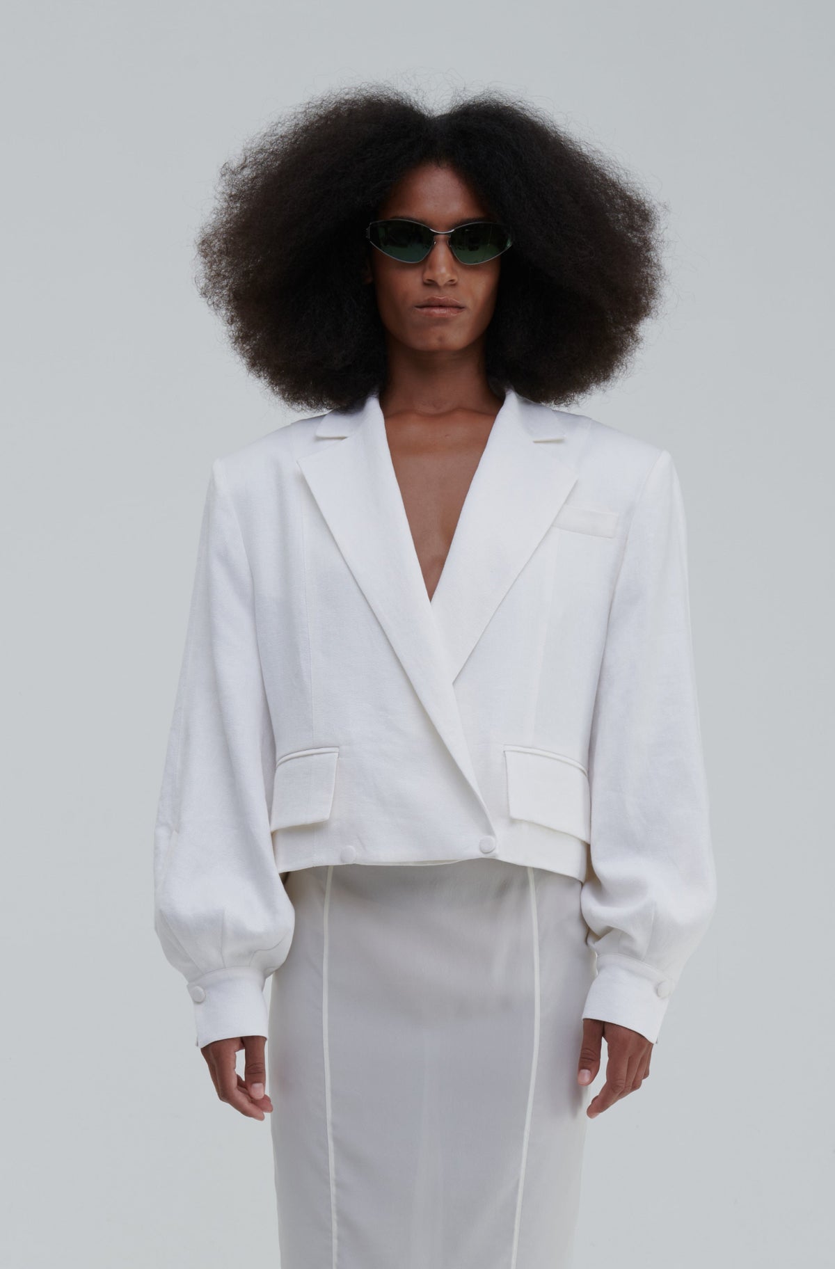 DOUBLE-BREASTED LINO BLAZER by Sagio from the Spring/Summer 2025 collection — a light beige, double-breasted linen blazer with a soft tailored shape, clean lines, and classic peak lapels. Timeless minimalist style from thesagio.com