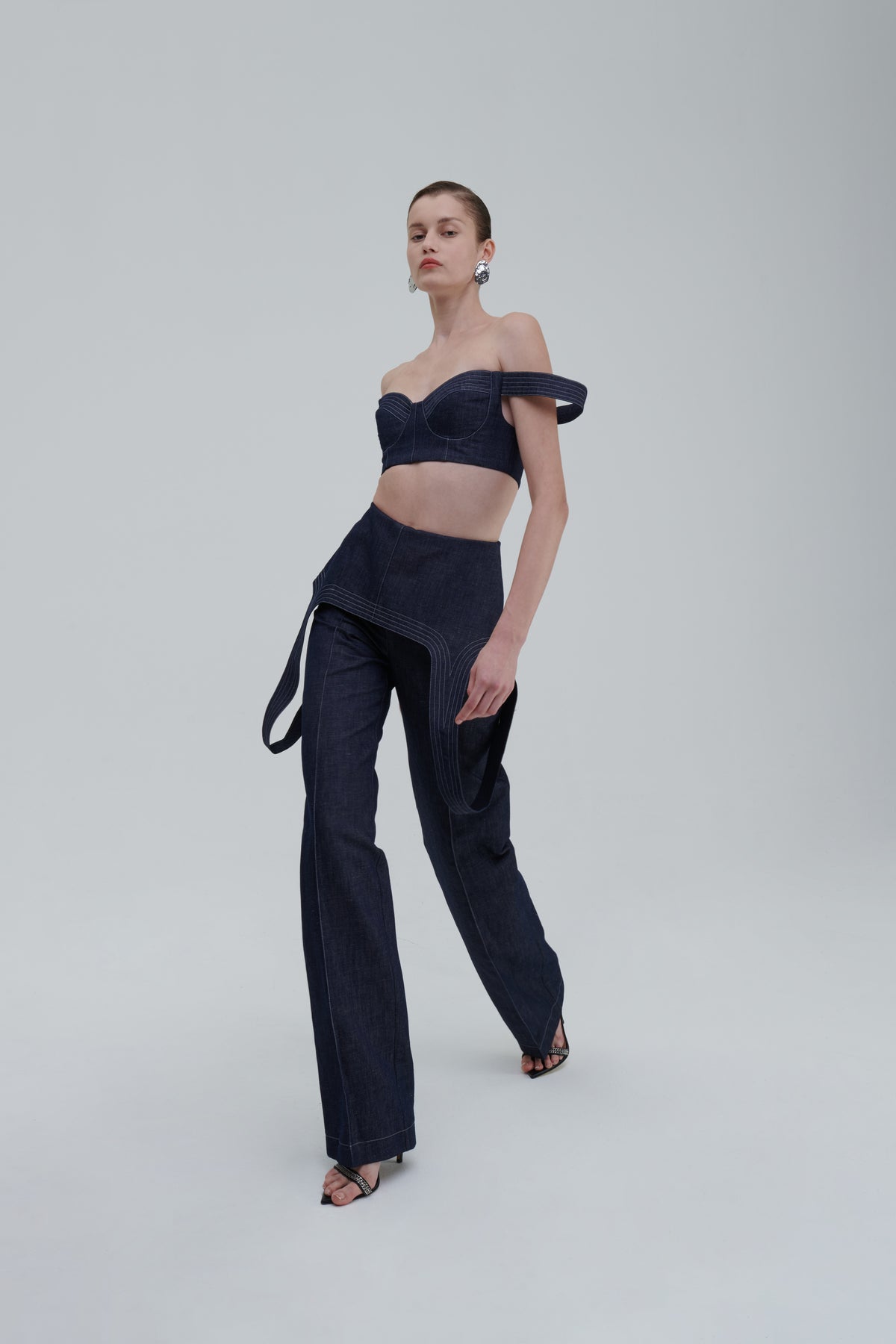 Dark blue high-waisted denim trousers three-quarter view on model