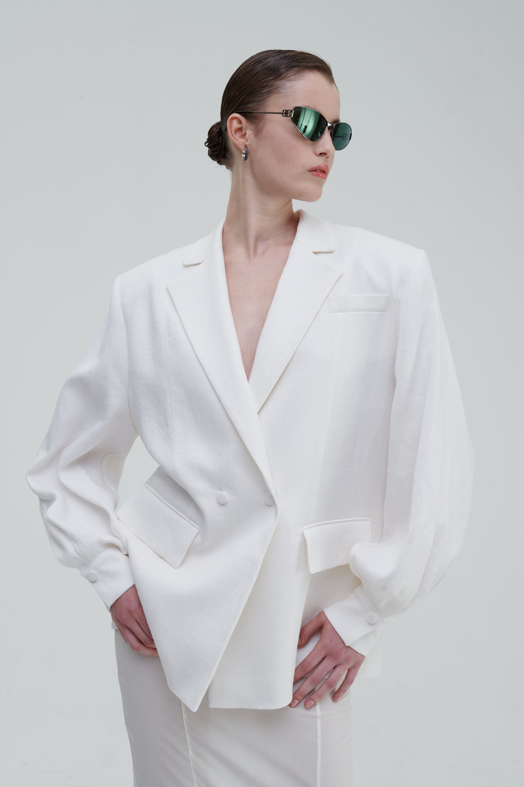 LINO DOUBLE-BREASTED BLAZER by Sagio from the Spring/Summer 2025 collection — a structured, double-breasted linen blazer in natural beige, featuring peak lapels, front pockets, and a refined minimalist silhouette. Discover elevated tailoring at thesagio.com