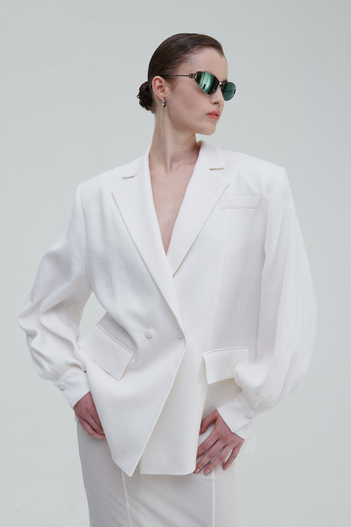 LINO DOUBLE-BREASTED BLAZER by Sagio from the Spring/Summer 2025 collection — a structured, double-breasted linen blazer in natural beige, featuring peak lapels, front pockets, and a refined minimalist silhouette. Discover elevated tailoring at thesagio.com