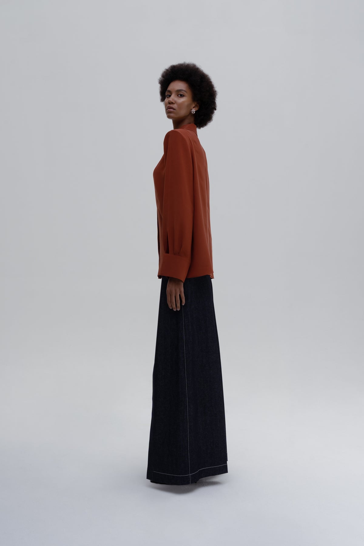 Silk Shirt by Sagio, featuring a relaxed-fit, long-sleeve red silk blouse with a classic collar and concealed button placket, side view. 