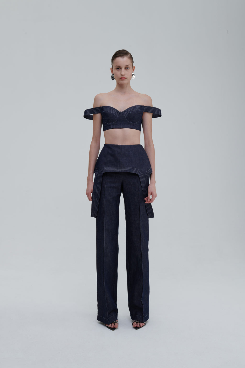 Dark blue denim falling trousers front view on model with matching top