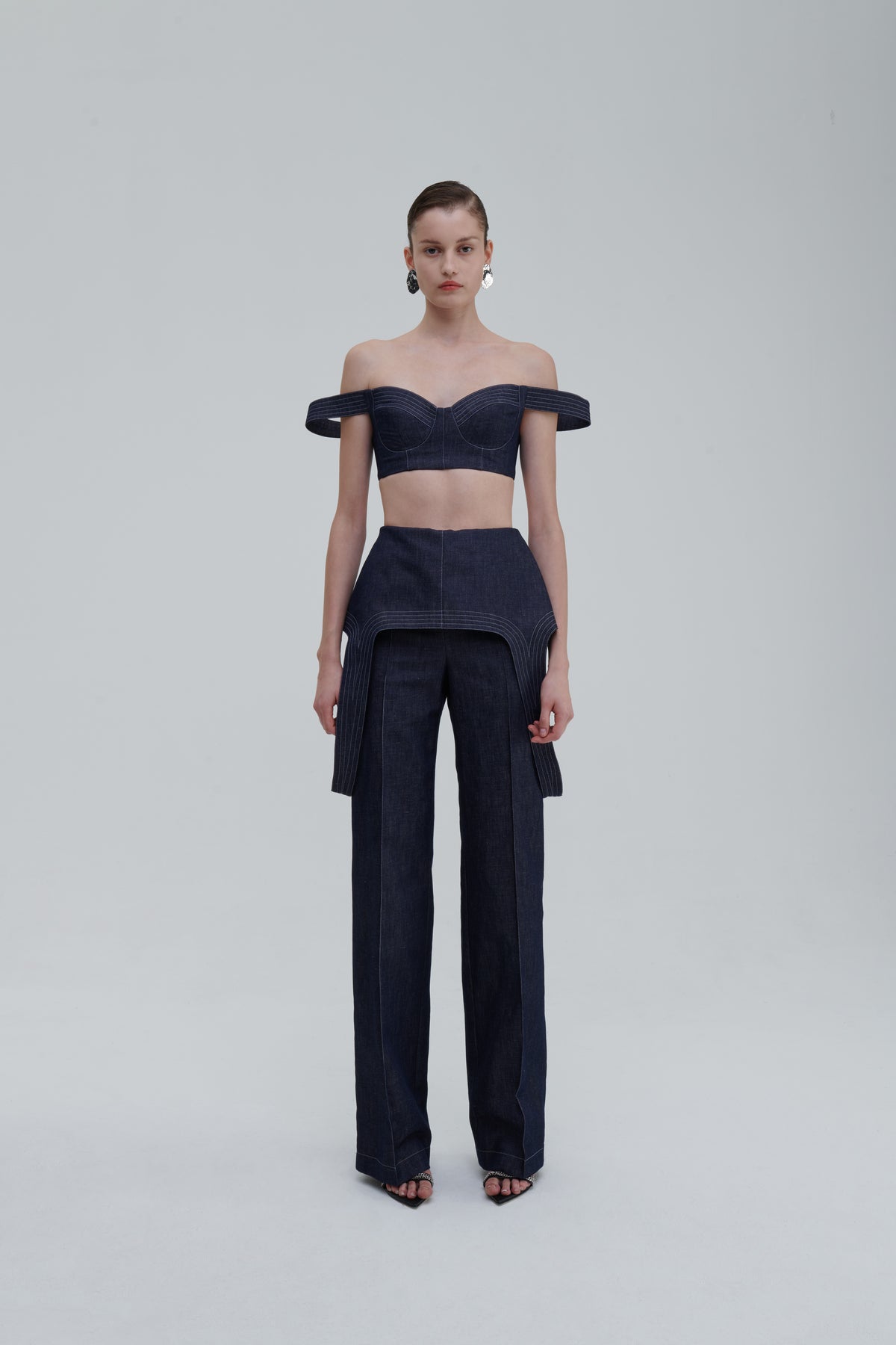 Dark blue denim falling trousers front view on model with matching top