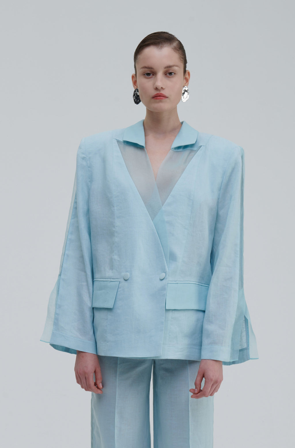 Light blue linen silk blazer front view on model with translucent lapels