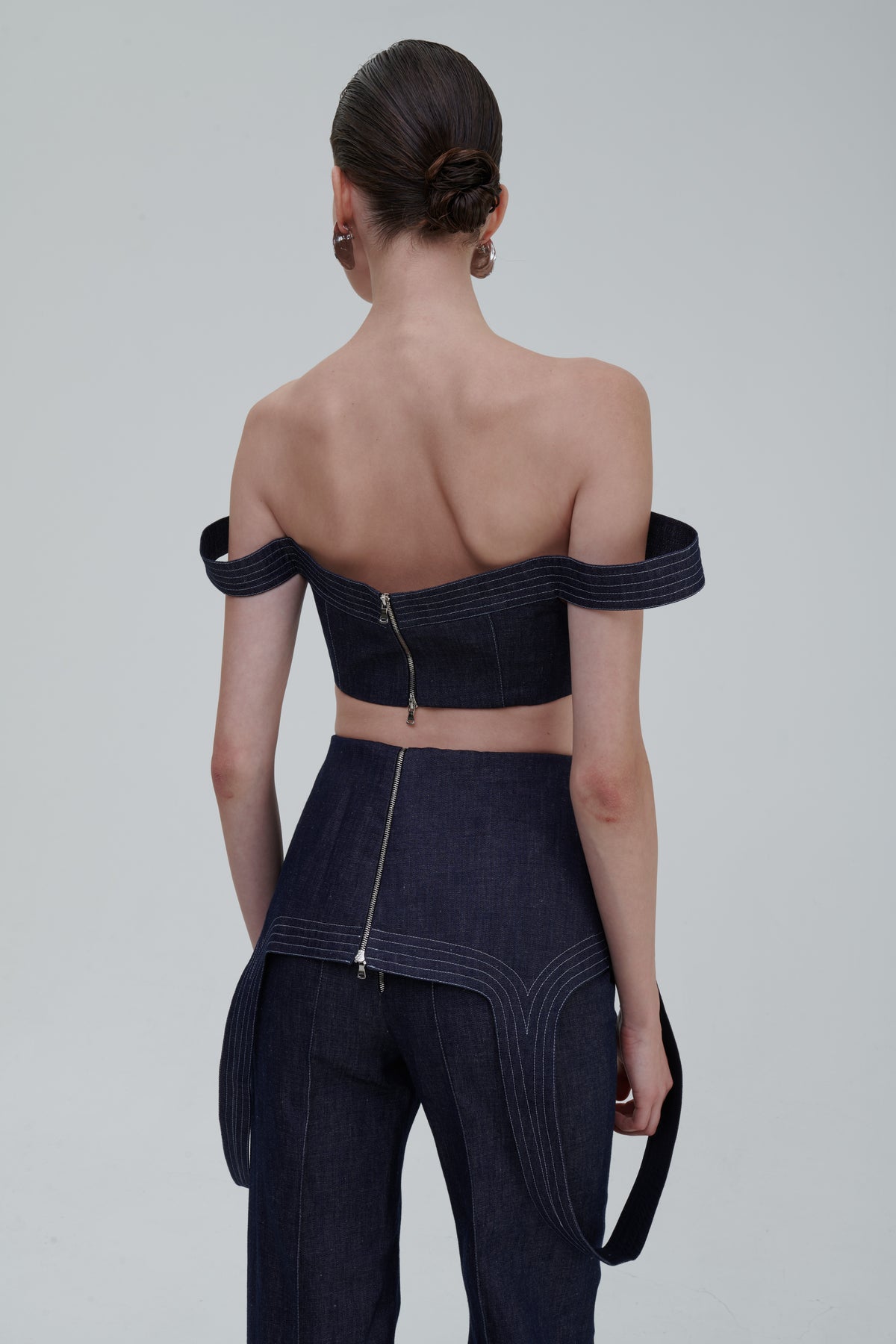Back view of SAGIO Denim Falling Top with exposed back zip and matching denim trousers