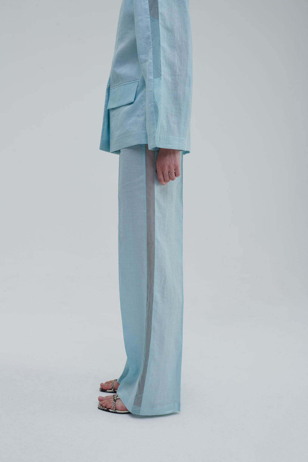 Light blue trousers side view on model with sheer panel detail