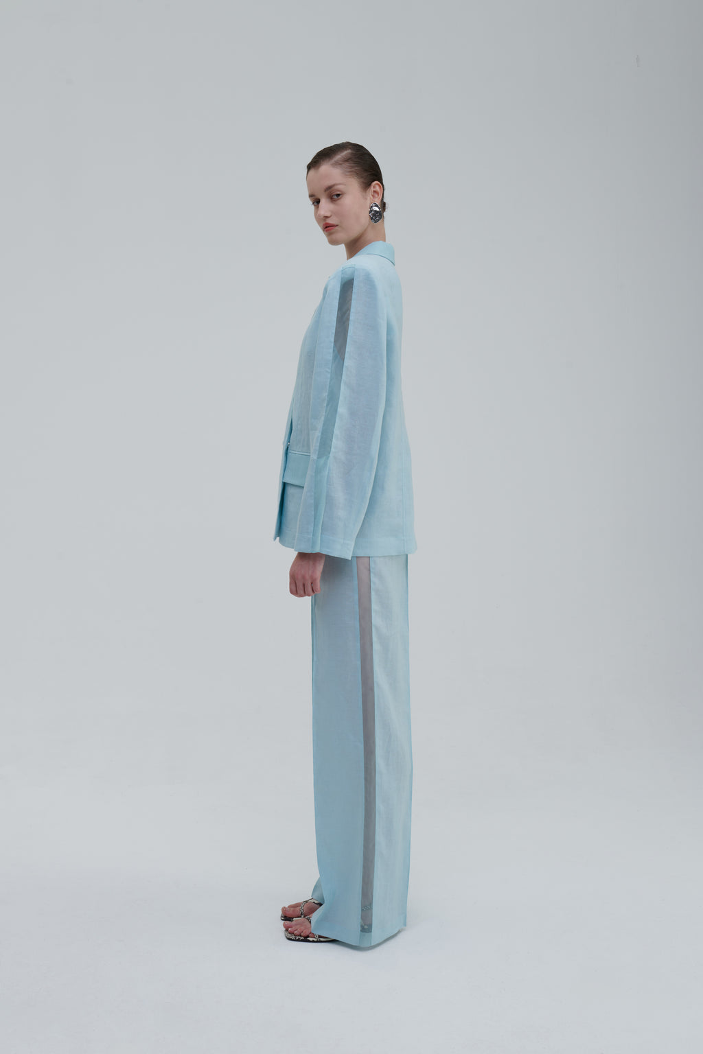 Light blue semi-sheer blazer side view on model with matching trousers