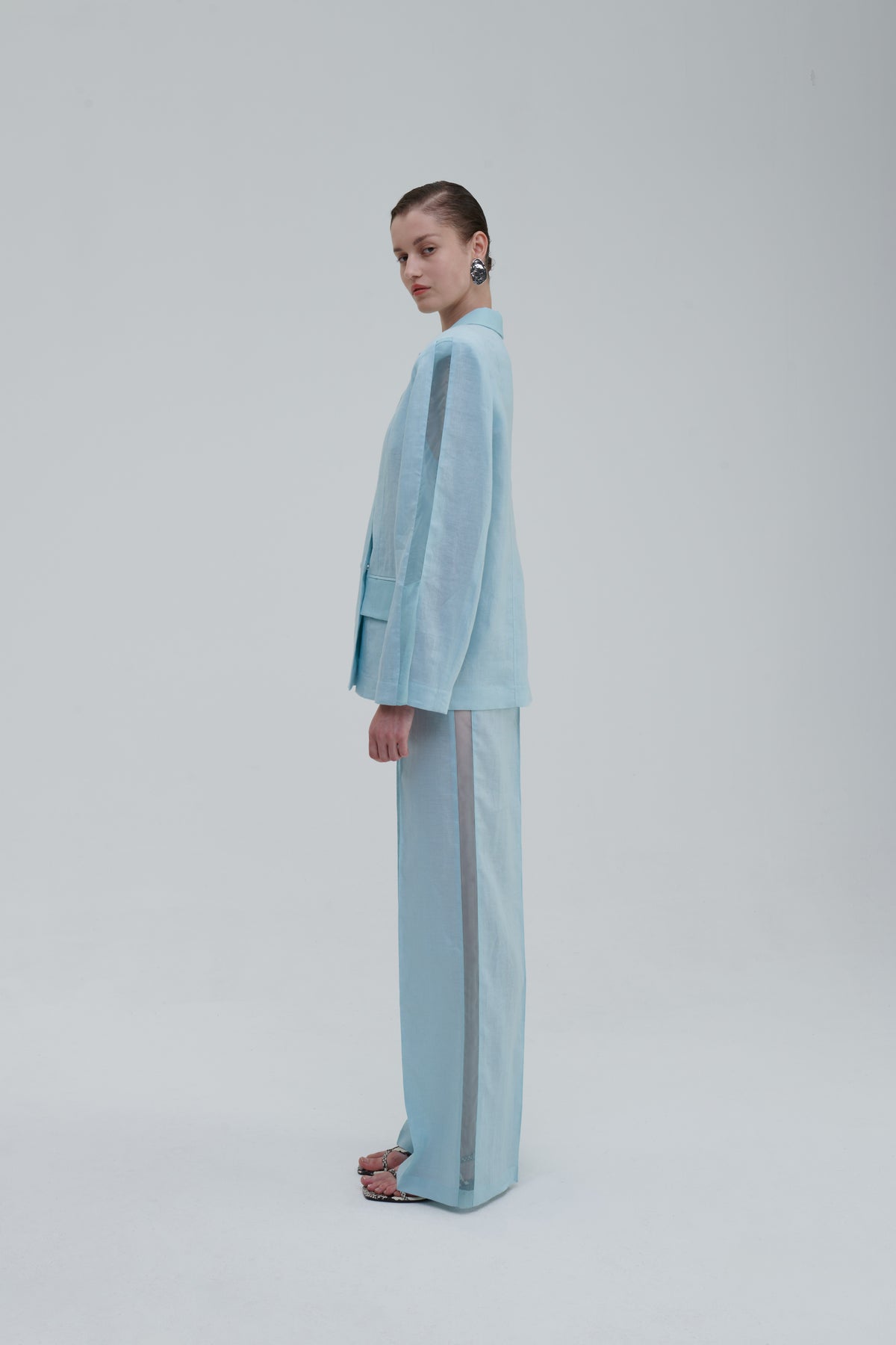 Light blue semi-sheer blazer side view on model with matching trousers